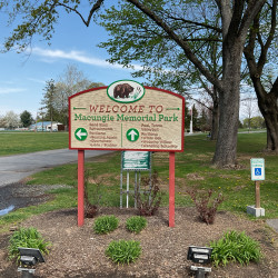 Entrance to Macungie Park - Welcome sign and paved walkway. Includes sign for handicap parking.